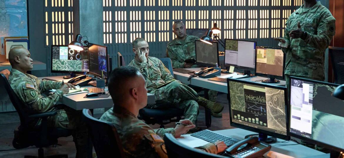 Soldiers in combat uniform working in a command center