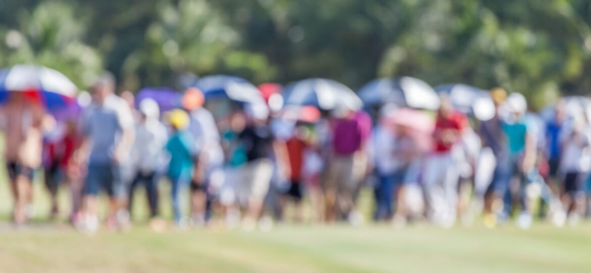 Blurred photo of group audience moving in golf tournamet.