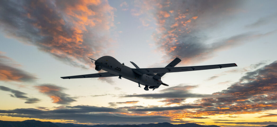 Military UAV spy drone flying over at the sunset