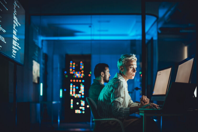 Caucasian female IT engineer working in server room